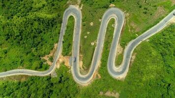 Aerial view 4k video by drone. Top View Of The Curve road Through The Trees