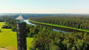 Aerial view young couple steps into famous Birstonas sightseeing tower landmark with Nemunas river and scenic forest panoramic view. Travel summer holiday destination in Lithuania. video