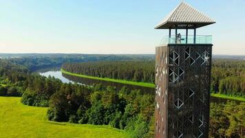 Static view tourists standing on top look out Birstonas observation tower - highest such tower in Lithuania. Drone aerial outdoors summer landscape view Nemunas panorama in Birstonas. video