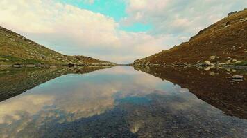 Time lapse of pristne alpine lake in autumn with reflections and people in motion. Caucasus region famous travel destination in Sakartvelo video