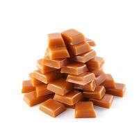 Heap of caramel candy with caramel topping on white backgrounds. photo