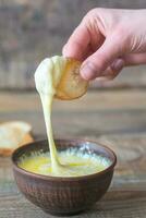 Bowl of cheese dip with toasts photo