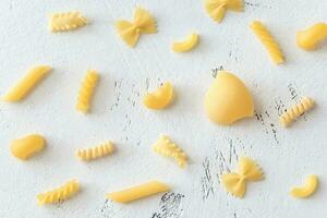 Various types of pasta on the white background photo