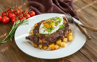 Beefsteak with fried egg photo