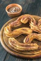 Churros with chocolate sauce photo