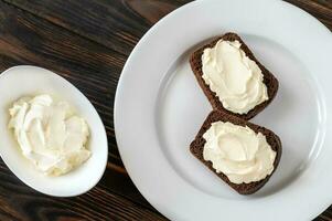 Slices of rye bread with cream cheese photo