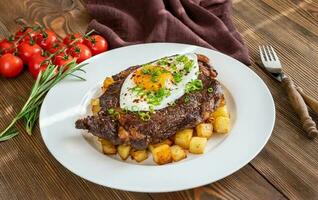 Beefsteak with fried egg photo