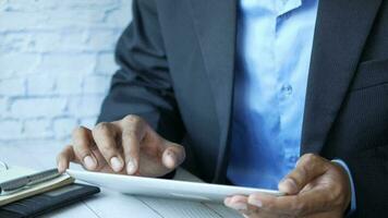 Businessman using digital tablet on office desk video