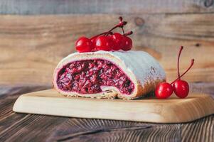 Cherry strudel on wooden background photo