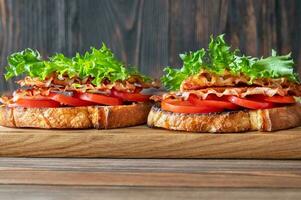 BLT sandwiches on the wooden board photo