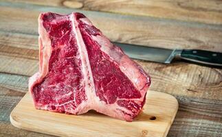 T-bone steak on the wooden board photo