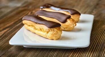 Eclairs with chocolate topping photo