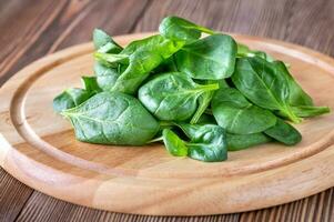 Fresh spinach on the wooden board photo