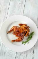 Roasted chicken on the white plate photo