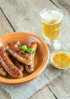 Grilled sausages with glass of beer photo