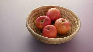 hand pick fresh apple in a bowl on wooden table video