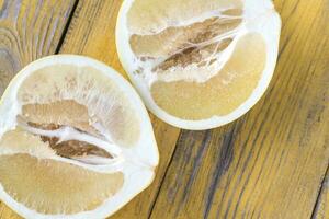 Pomelo on the wooden table photo