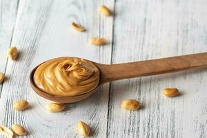 Wooden spoon of peanut butter photo