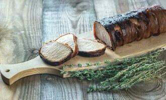 Pork loin wrapped in bacon photo
