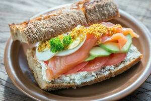 Sandwich with salmon, avocado and eggs photo