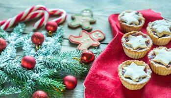 Decorated Christmas tree branch with holiday pastry photo