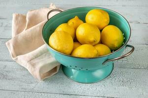 Fresh lemons in the colander photo