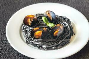 Black pasta with mussels photo