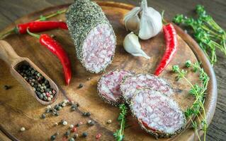 Slices of saucisson on the wooden board photo