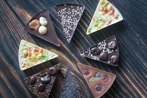 Chocolate candies with different toppings photo