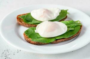 Sandwiches with spinach and poached egg photo