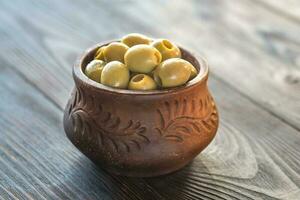 Bowl of olives on the wooden table photo