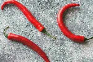 Fresh chili peppers on the gray background photo