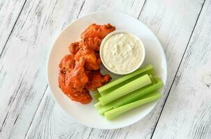 Bowl of buffalo wings with blue cheese dip photo