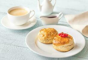 Classic scones with cream and berry jam photo