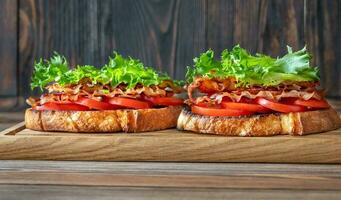 BLT sandwiches on the wooden board photo