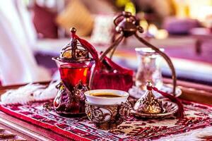 Turkish tea and sweets in decorative ware, candies photo
