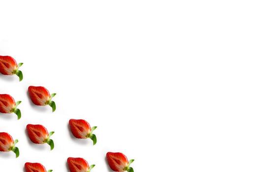 Strawberries in the corner of the frame on a white background. Pattern of halves of berries with a place for text. Top view. Flat lay photo