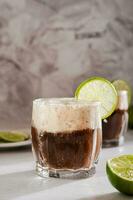 Homemade dirty soda with cola and lime in glasses on the table vertical view photo