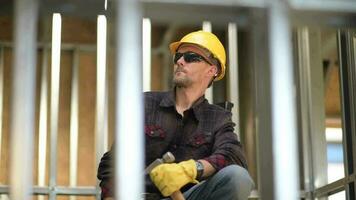 Caucasian Builder with Hammer and the Construction Site. video