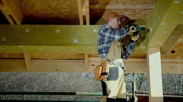 Contractor Worker in His 30s Attaching Blocks of Insulation Mineral Wool to House Elements. video