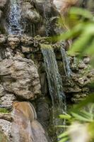 Rocky terrain with a waterfall and a pond. Russia. photo