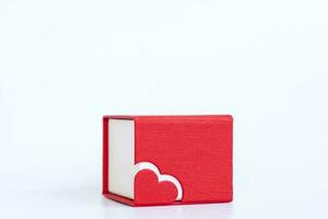 Red box for decoration with a heart on a white background. Make a Declaration of love. The concept of the Valentine's Day theme. photo