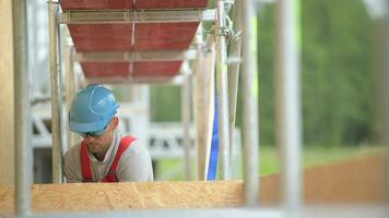 Caucasian Contractor Worker in His 30s on a Scaffolding. Work at Height. video