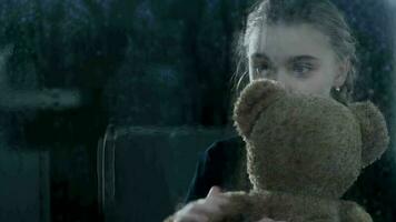 School Age Child Holds Teddy Bear While Looking Through A WIndow. video