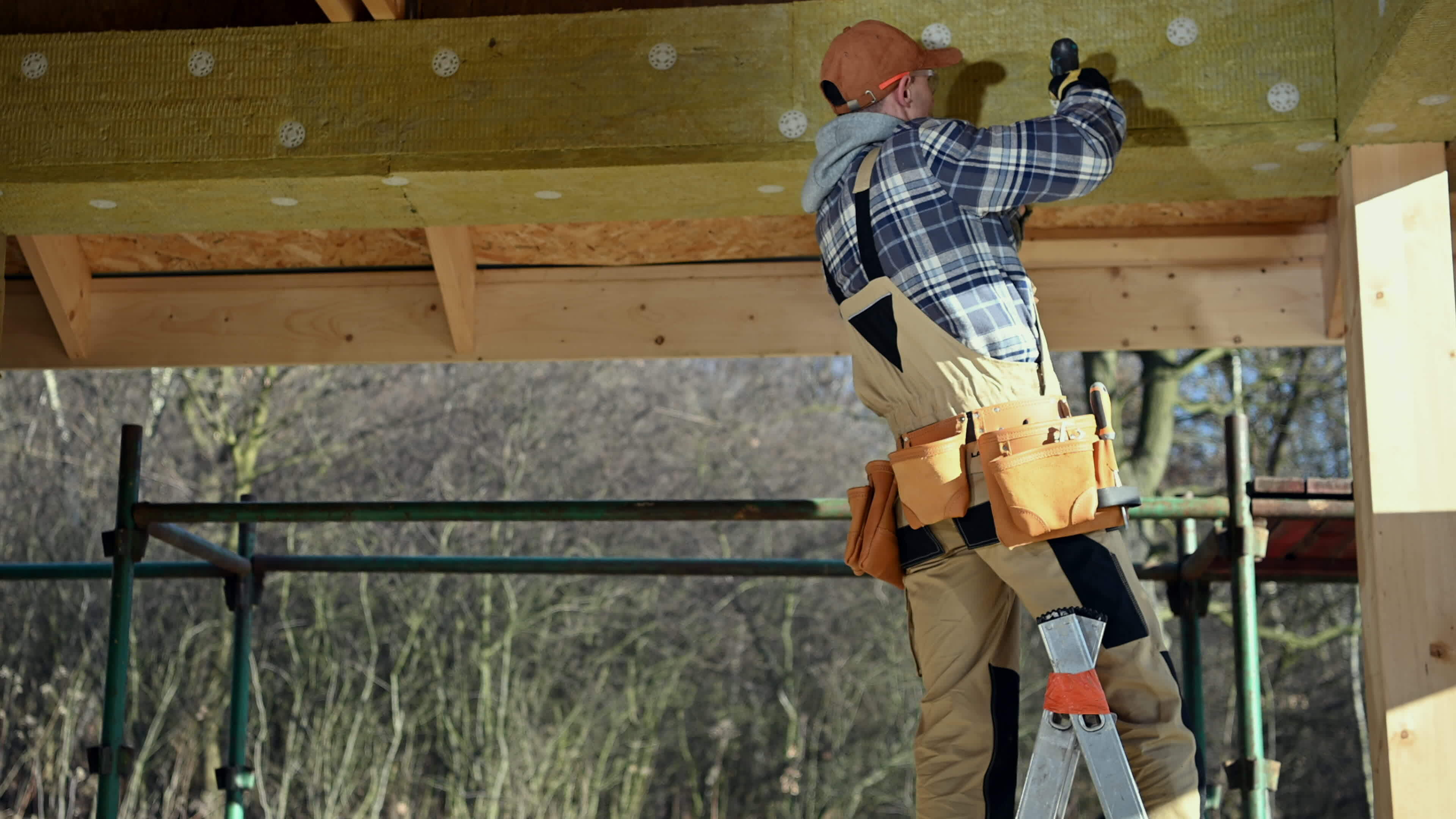Professional Contractor Worker Attaching Blocks of Insulation Mineral