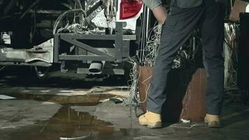 Mechanic Sorting Through Bin Filled With Used Electric Wire. video