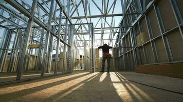 Hard Hat Wearing Contractor in the Construction Zone. Steel Frame of the House video