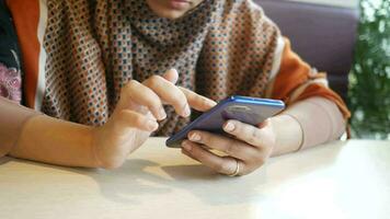 Close up of woman hand holding smart phone video