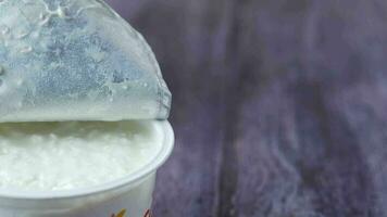 Cottage cheese in a plastic container on table video