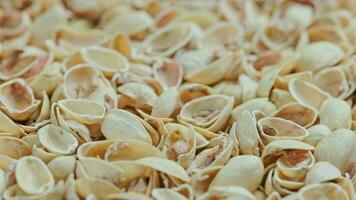 looped rotating empty pistachios shells full frame close-up background video